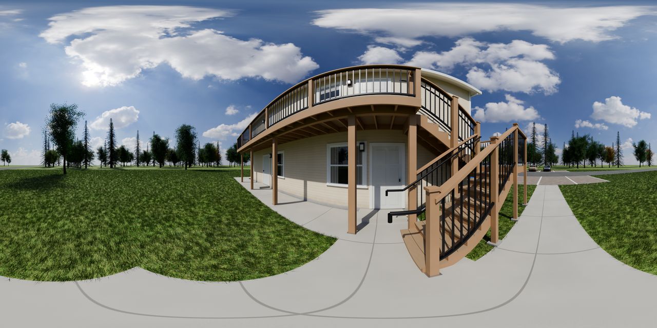 The two-story 8-plex with its second-floor walkway and stair, seen from the walk.